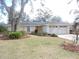 Single story home with mature landscaping and a two-car garage at 1163 Cephia St, Lake Wales, FL 33853