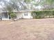 Back exterior of house showing screened porch and yard at 1163 Cephia St, Lake Wales, FL 33853