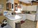 Galley-style kitchen with white cabinets and a breakfast bar at 1163 Cephia St, Lake Wales, FL 33853