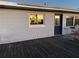 Wooden back deck with a blue door and window at 2000 Mcclellan Rd, Frostproof, FL 33843