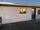 Wooden back deck with a blue door and window at 2000 Mcclellan Rd, Frostproof, FL 33843