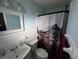 Clean bathroom with white tile and a shower/tub combo at 2000 Mcclellan Rd, Frostproof, FL 33843