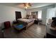 Large main bedroom with wood-look floors and a ceiling fan at 2000 Mcclellan Rd, Frostproof, FL 33843