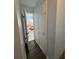 Hallway with wood-look floors and access to bathroom at 2000 Mcclellan Rd, Frostproof, FL 33843