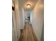 Long hallway with light wood-look floors at 2000 Mcclellan Rd, Frostproof, FL 33843