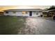 Newly painted light gray house with a blue door, and a grassy yard at 2000 Mcclellan Rd, Frostproof, FL 33843