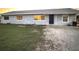 Newly painted light gray house with a blue door, and a grassy yard at 2000 Mcclellan Rd, Frostproof, FL 33843