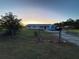 Ranch style house with a large yard at sunset at 2000 Mcclellan Rd, Frostproof, FL 33843