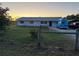 Ranch style house with a large yard at sunset at 2000 Mcclellan Rd, Frostproof, FL 33843