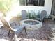 Relaxing backyard patio with fire pit and three chairs at 2153 Capps Rd, Lake Wales, FL 33898