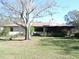 Back exterior of house showing screened porch and landscaping at 2153 Capps Rd, Lake Wales, FL 33898