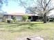 Back exterior view of house with landscaping and lawn at 2153 Capps Rd, Lake Wales, FL 33898