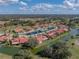 High angle view of a community featuring single Gathering homes, a community pool, and lush landscaping with golf course beyond at 2680 Clubhouse Dr, Lake Wales, FL 33898