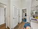 Hallway leading to the bright bathroom features wood-look floors, and lots of linen storage at 2680 Clubhouse Dr, Lake Wales, FL 33898