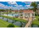 An inviting community pool is pictured with a gazebo and outdoor seating areas with palm trees and tropical landscaping at 2680 Clubhouse Dr, Lake Wales, FL 33898