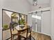 A dining area featuring a view of the courtyard, sliding doors, and modern lighting at 2680 Clubhouse Dr, Lake Wales, FL 33898