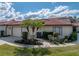 Charming home featuring a red tile roof, mature landscaping, and an attached two-car garage at 2680 Clubhouse Dr, Lake Wales, FL 33898