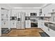 Modern kitchen featuring stainless steel appliances, white cabinets, and a farmhouse sink at 2680 Clubhouse Dr, Lake Wales, FL 33898