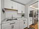 Well-lit kitchen with white cabinets, stainless steel appliances, marble countertops, and modern fixtures at 2680 Clubhouse Dr, Lake Wales, FL 33898