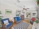 Cozy living room featuring comfortable wicker seating, patterned rugs, and abundant natural light at 2680 Clubhouse Dr, Lake Wales, FL 33898