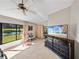 Spacious main bedroom overlooking a serene pond, and a view to the dining room at 2680 Clubhouse Dr, Lake Wales, FL 33898