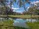 Picturesque pond with lush trees and clear skies, perfect for a tranquil and scenic setting at 2680 Clubhouse Dr, Lake Wales, FL 33898