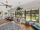 Bright sunroom with floor-to-ceiling windows offering serene views of the water and lush landscaping at 2680 Clubhouse Dr, Lake Wales, FL 33898