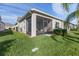 Landscaped backyard with screened patio and lush green lawn at 3020 Caneel St, Winter Haven, FL 33884