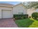 Tan house with a two-car garage and neatly landscaped front yard at 3020 Caneel St, Winter Haven, FL 33884