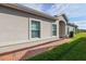 Brick walkway leads to the entrance of a tan house with red mulch at 3020 Caneel St, Winter Haven, FL 33884