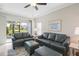 Living room with gray couches, a large window, and access to a patio at 3020 Caneel St, Winter Haven, FL 33884