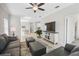 Open concept living room with gray couches and a large TV at 3020 Caneel St, Winter Haven, FL 33884