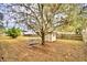 Backyard with shed and picnic table under a large tree at 337 Swingle St, Frostproof, FL 33843