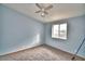 Light blue bedroom with ceiling fan and carpet at 337 Swingle St, Frostproof, FL 33843