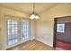 Bright dining area with backyard access and wood flooring at 337 Swingle St, Frostproof, FL 33843