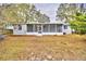 Back of house with screened porch and yard at 337 Swingle St, Frostproof, FL 33843