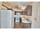 Updated kitchen with dark wood cabinets and laminate floors at 337 Swingle St, Frostproof, FL 33843