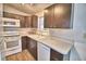 Bright kitchen features white appliances and dark brown cabinets at 337 Swingle St, Frostproof, FL 33843