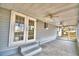 Covered porch with double doors and ceiling fans at 337 Swingle St, Frostproof, FL 33843