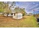 White storage shed in the backyard at 337 Swingle St, Frostproof, FL 33843