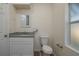 Neat bathroom featuring a toilet, granite vanity, and a window at 412 2Nd Sw St, Winter Haven, FL 33880