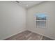 Simple bedroom with wood-look floors and a window with blinds at 412 2Nd Sw St, Winter Haven, FL 33880