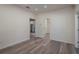 Bright and airy living room with wood-look floors and access to other rooms at 412 2Nd Sw St, Winter Haven, FL 33880