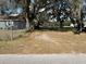 Spacious backyard with mature trees and a partially fenced area at 4718 Cynthia St, Bartow, FL 33830