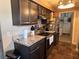 Kitchen with dark cabinets and granite countertops at 4718 Cynthia St, Bartow, FL 33830