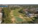 Scenic aerial view of the golf course with lush green fairways, sand bunkers, and beautiful homes at 5011 Hemingway Cir # 5011, Haines City, FL 33844