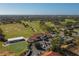 Expansive aerial view of the golf course clubhouse, surrounded by picturesque landscaping and a verdant golf course at 5011 Hemingway Cir # 5011, Haines City, FL 33844