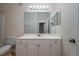 Bright bathroom featuring a white vanity, large mirror, and a clean, neutral color palette at 5011 Hemingway Cir # 5011, Haines City, FL 33844