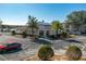 View of the community building surrounded by lush landscaping, trees, and ample parking at 5011 Hemingway Cir # 5011, Haines City, FL 33844