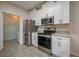 Modern kitchen features stainless steel appliances and white cabinets for a clean look at 5011 Hemingway Cir # 5011, Haines City, FL 33844